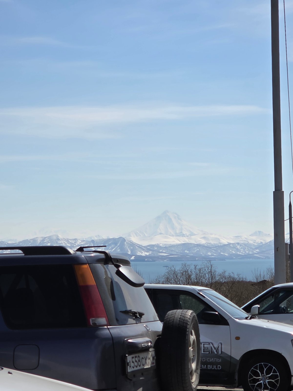 Mountain bay landscape observed with sparse vegetation, clear skies