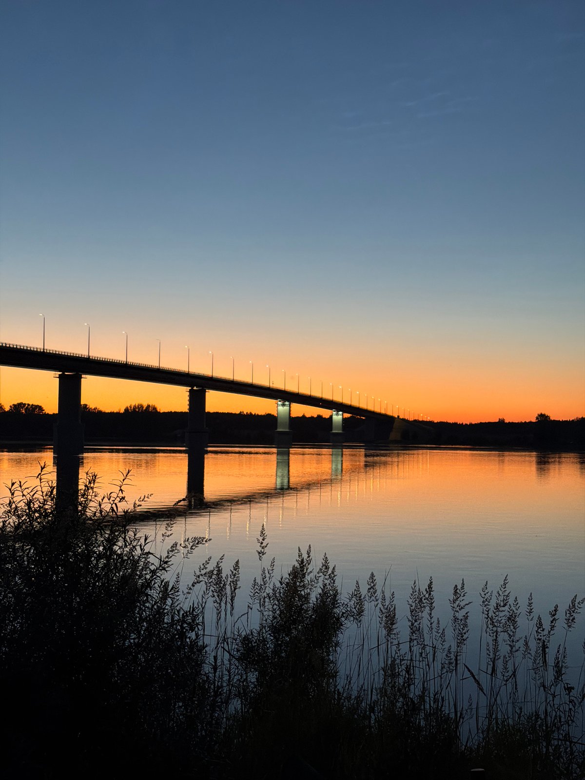 Sunset over a river bridge in Tarasovo, Russia
