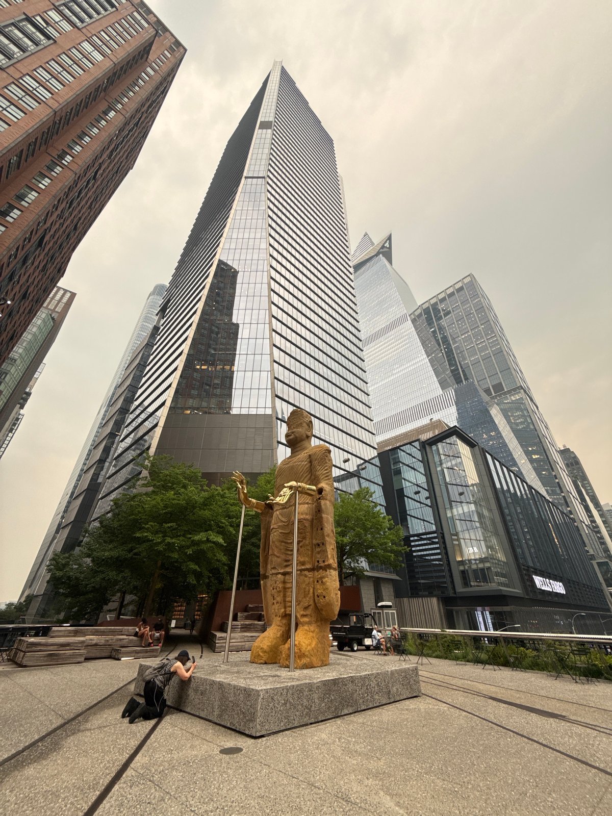 Golden statue and glass towers at Hudson Yards