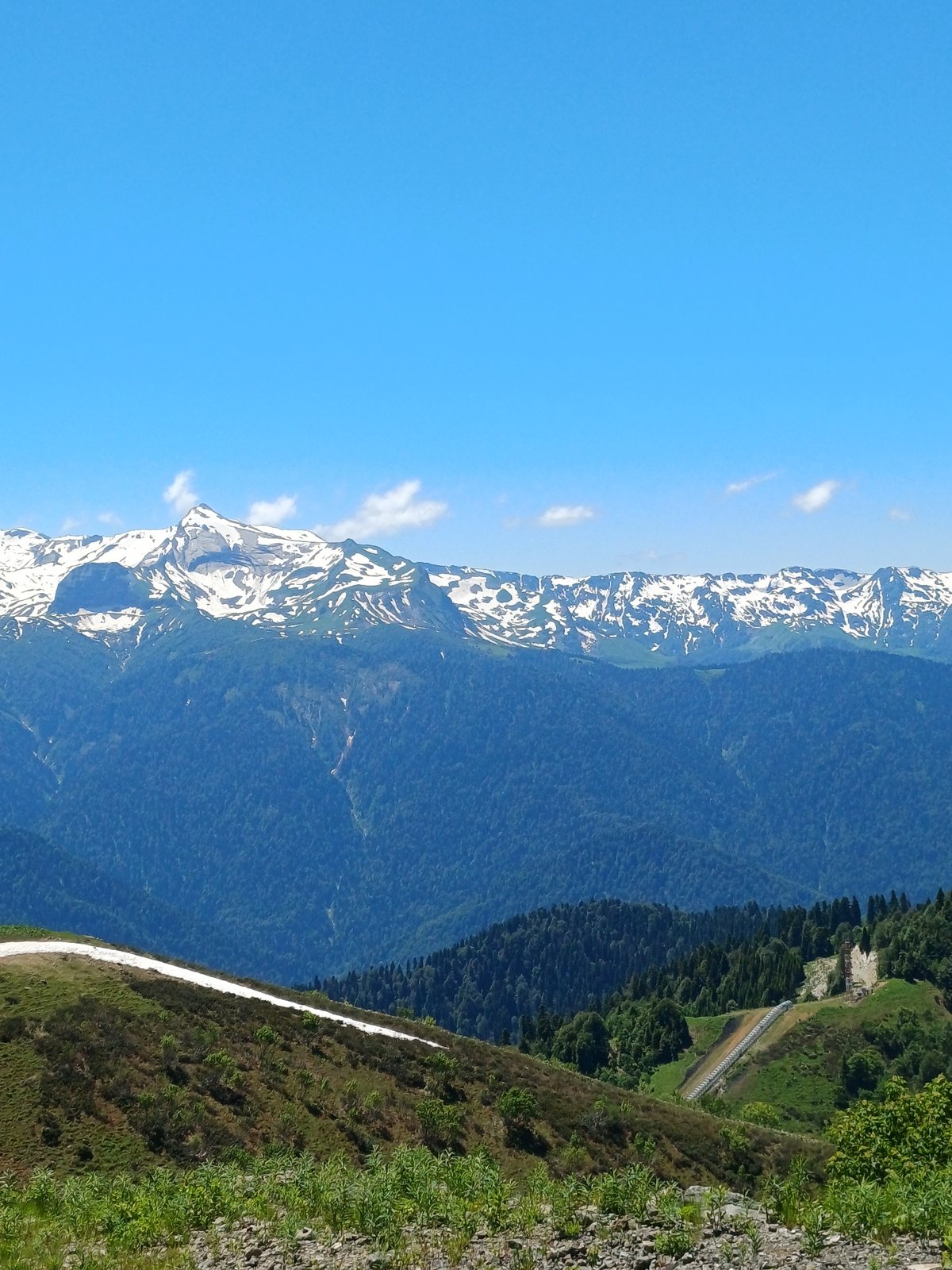 Mountain road drive through Estosadok's forested Caucasus peaks