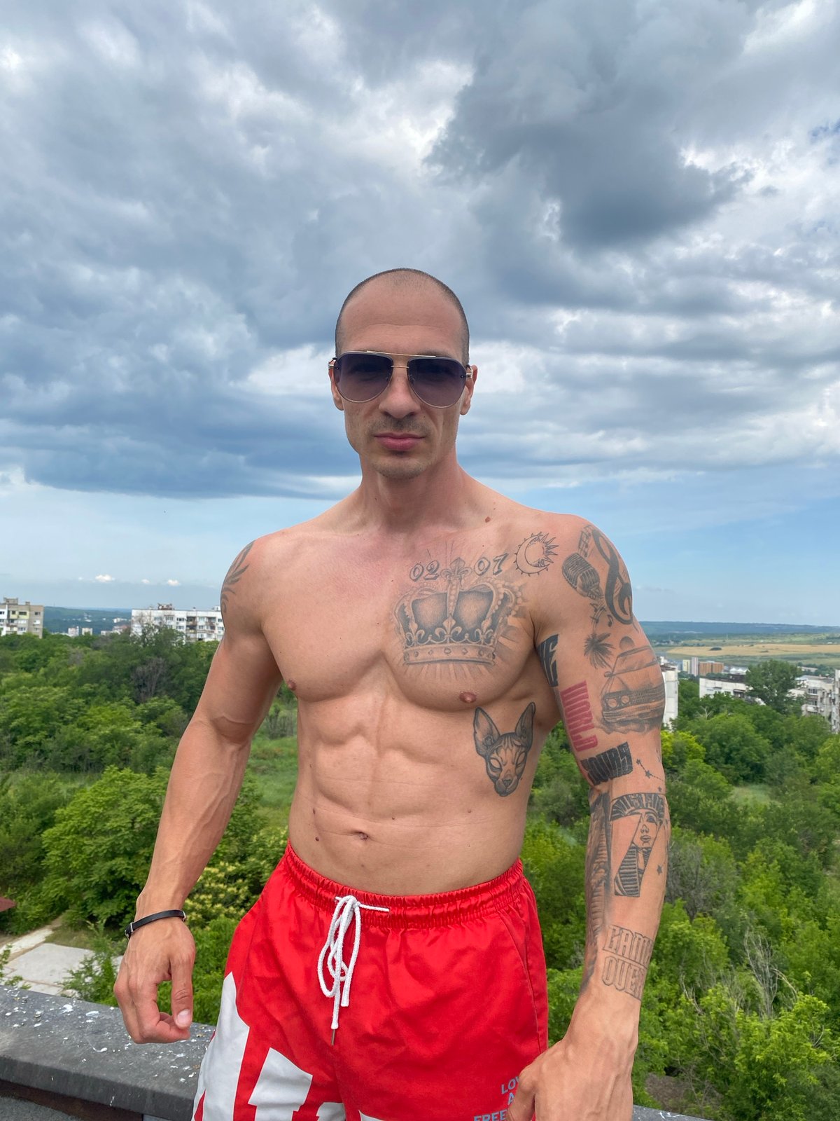 Tattooed man performs rooftop activities in Pleven, Bulgaria