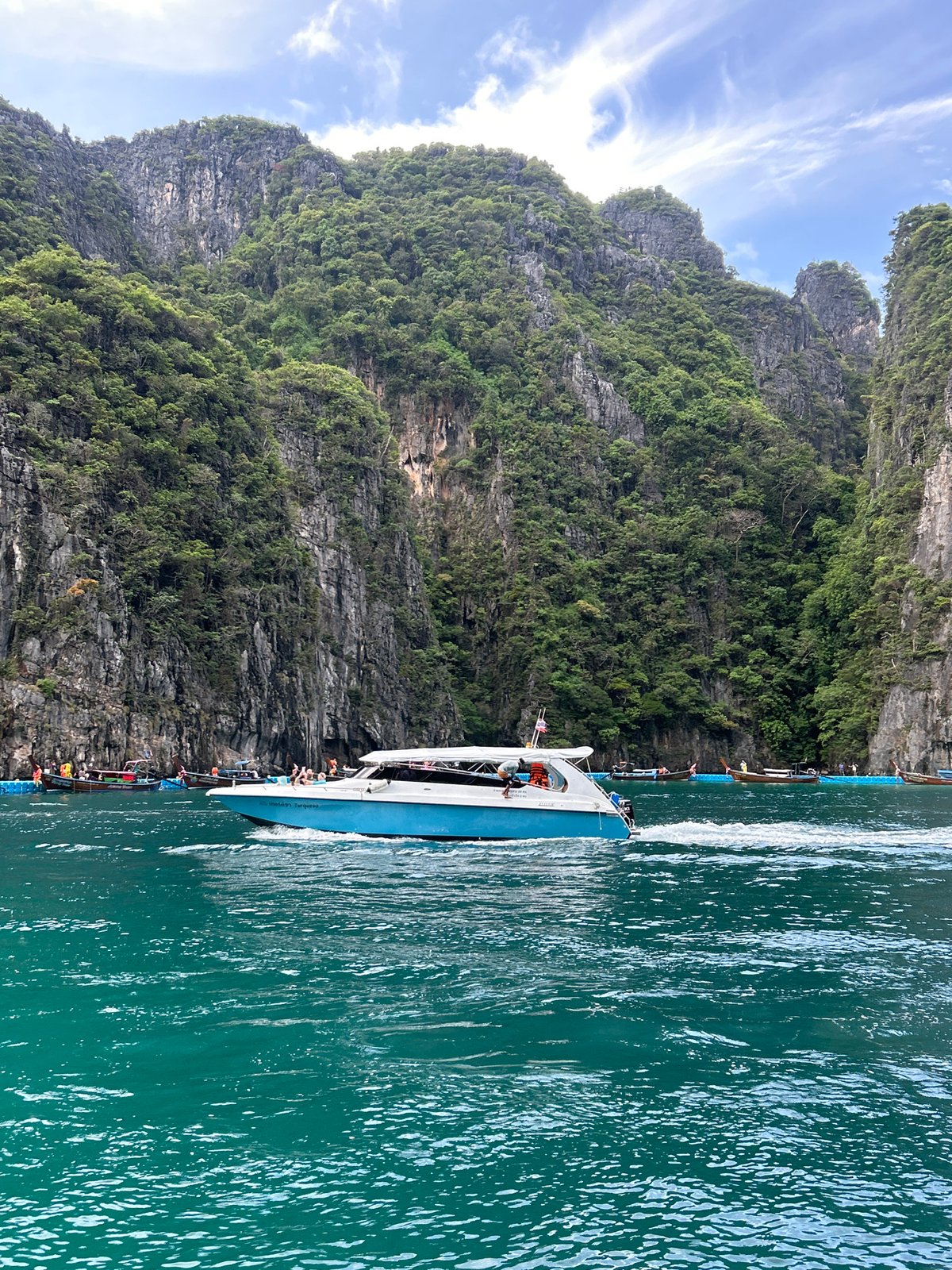 Speedboats and longtails navigate Ao Nang's limestone karst waters