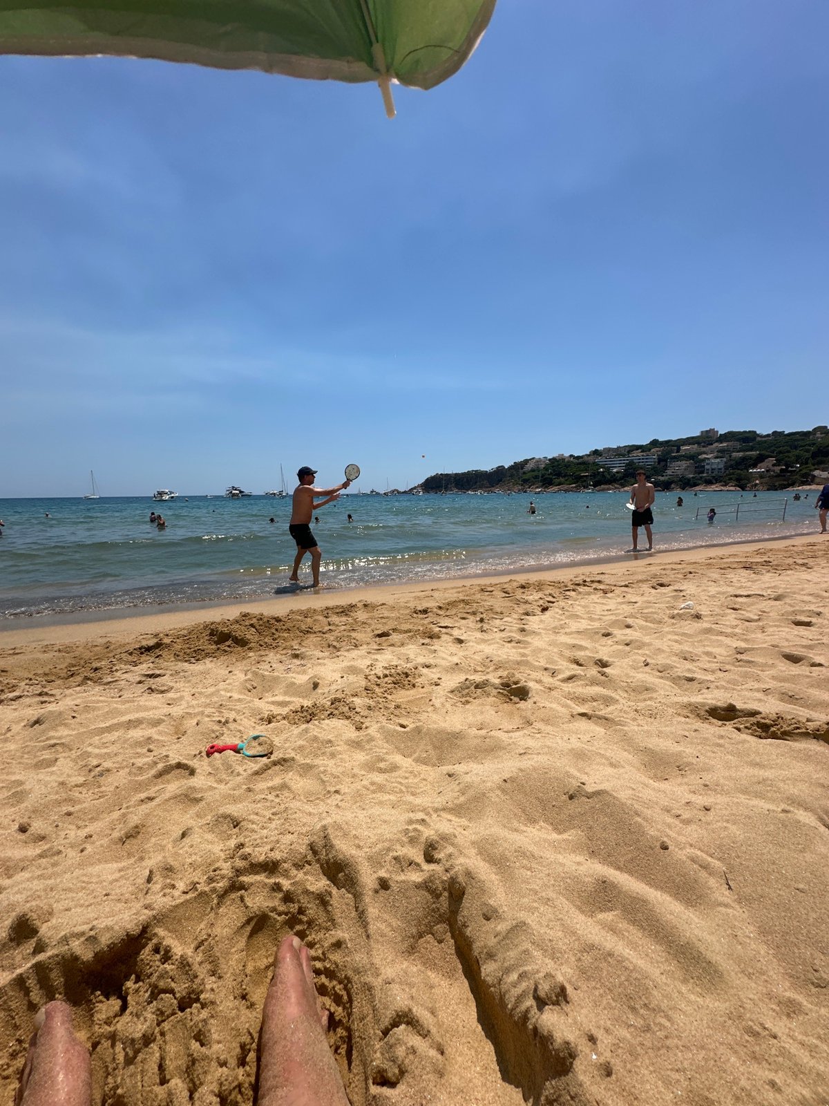 Busy summer beach day on the Costa Brava