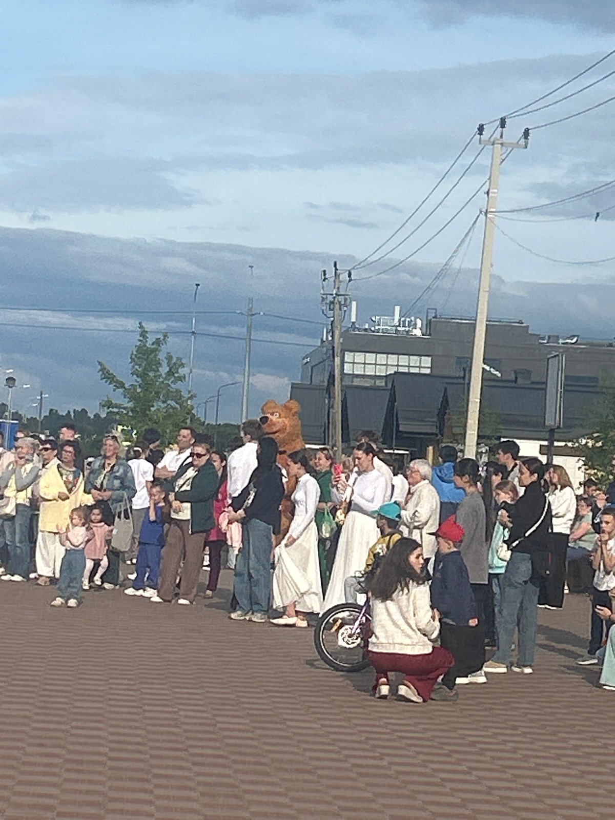 Costumed characters and performers at an outdoor plaza event
