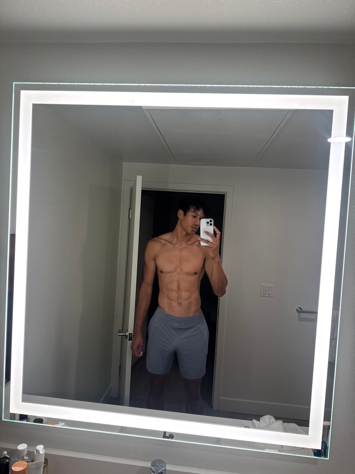 Man documents morning skincare routine in Los Angeles bathroom