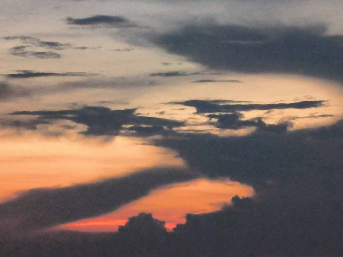Dramatic sunset illuminates dark clouds over Lhokseumawe seascape