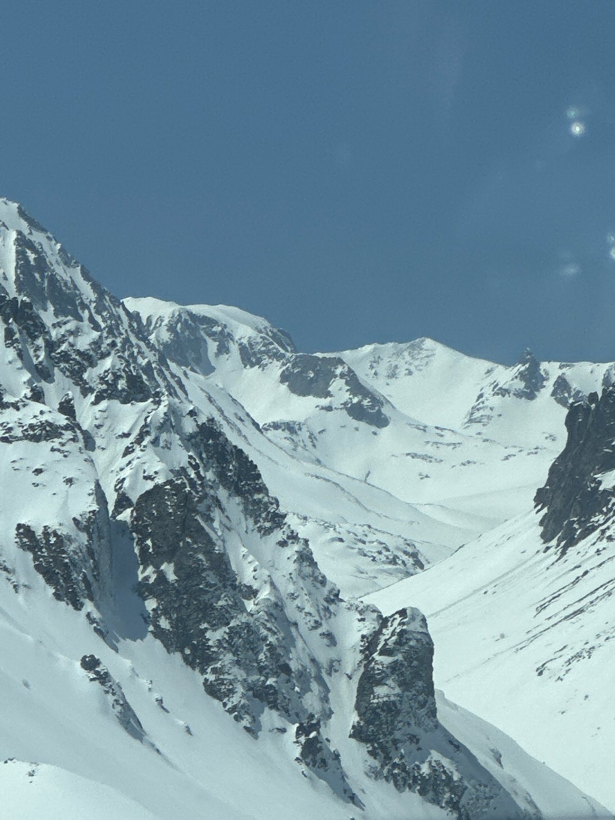 Snow-covered mountains documented under clear skies in Kajaran, Armenia