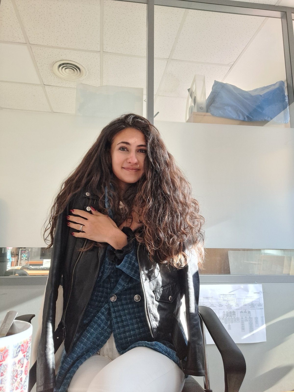Woman enjoys morning tea in Sofia office setting