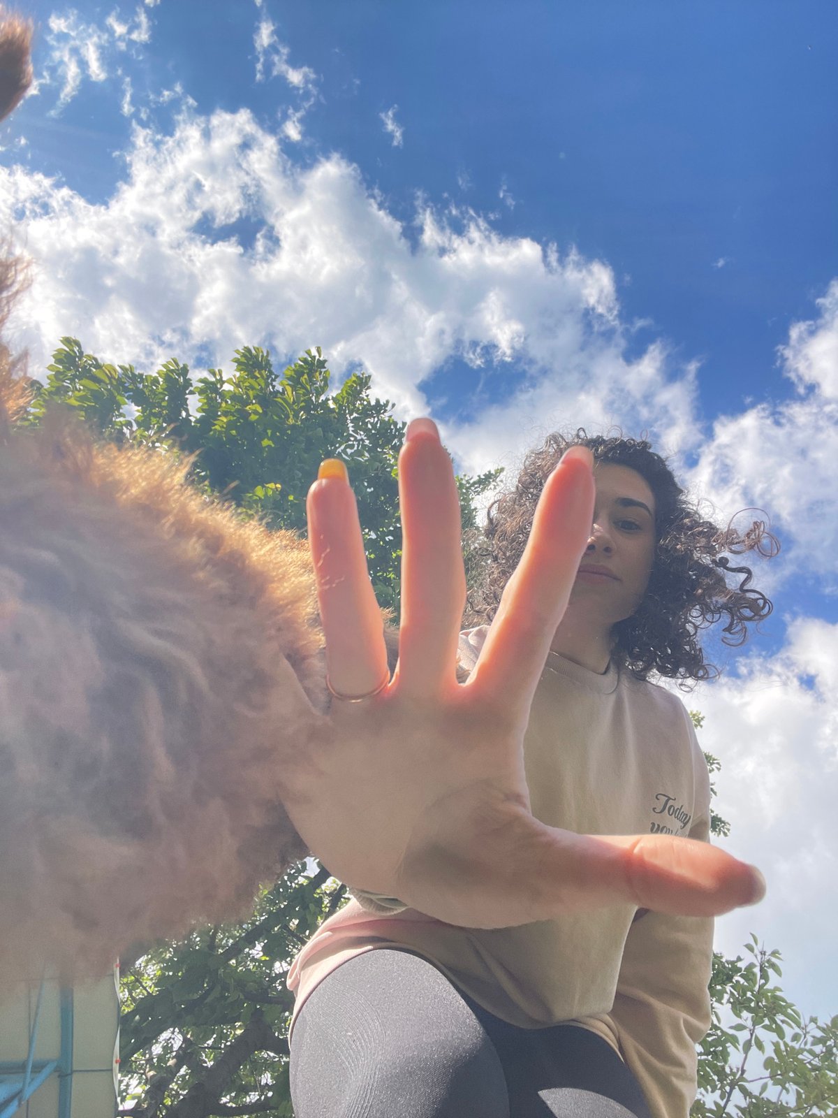 Woman plays with poodle in Sofia park