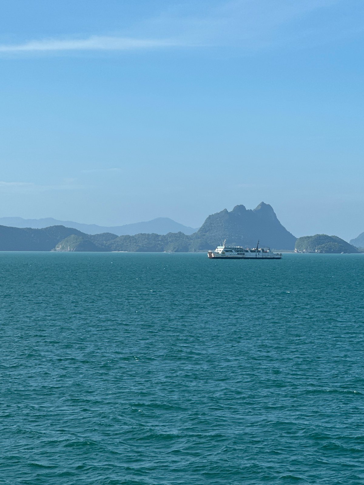 Ferry crossing calm turquoise waters off the Thai island coast