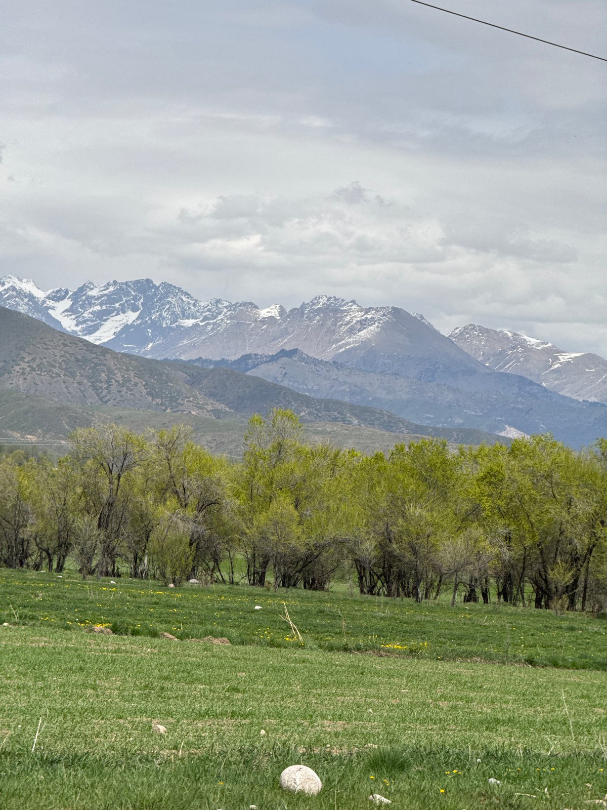 Mountain landscape documented in Grigor'yevka, Kyrgyzstan under overcast skies