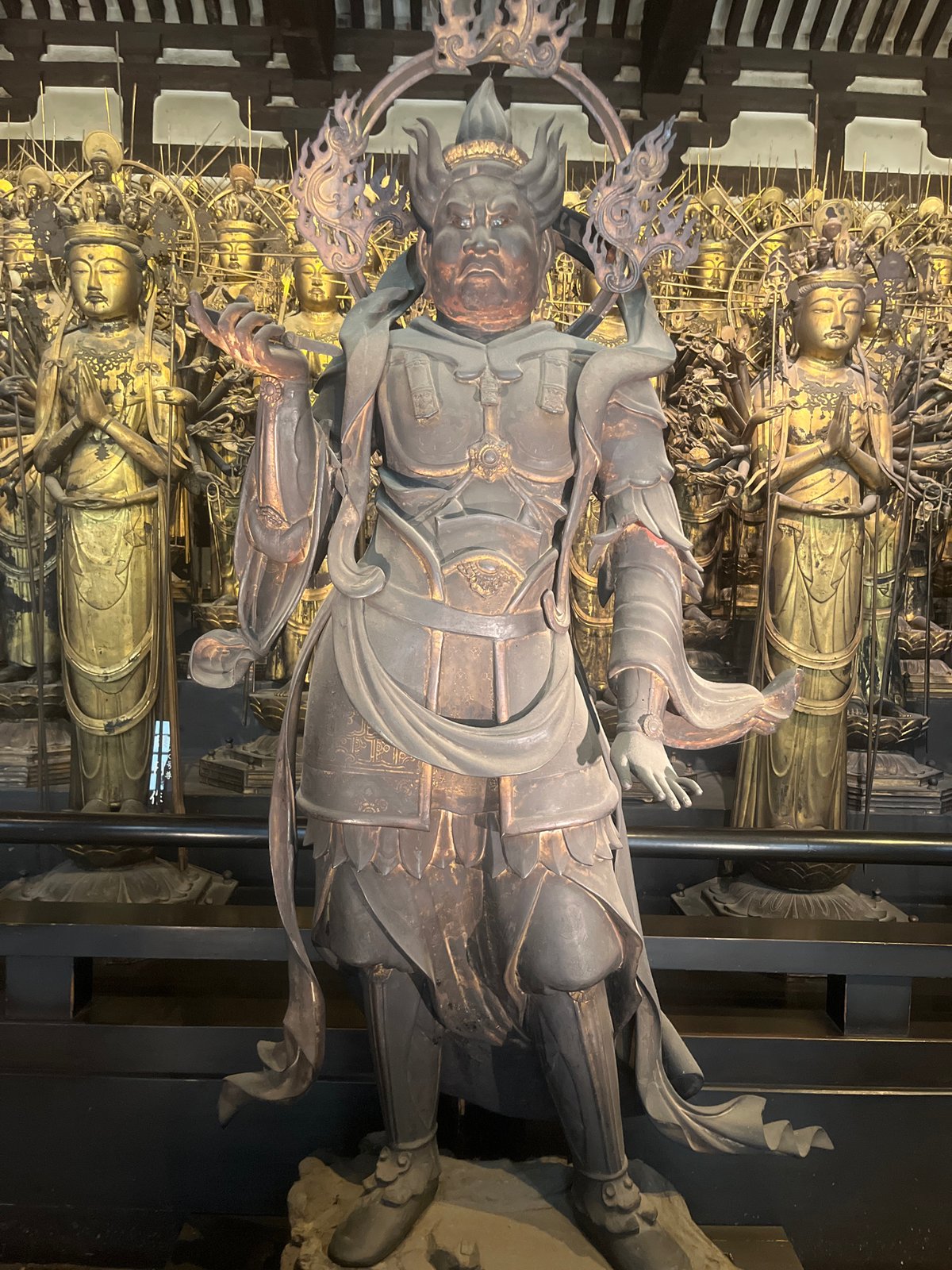Tourists explore famous Buddhist temple statues in Kyoto