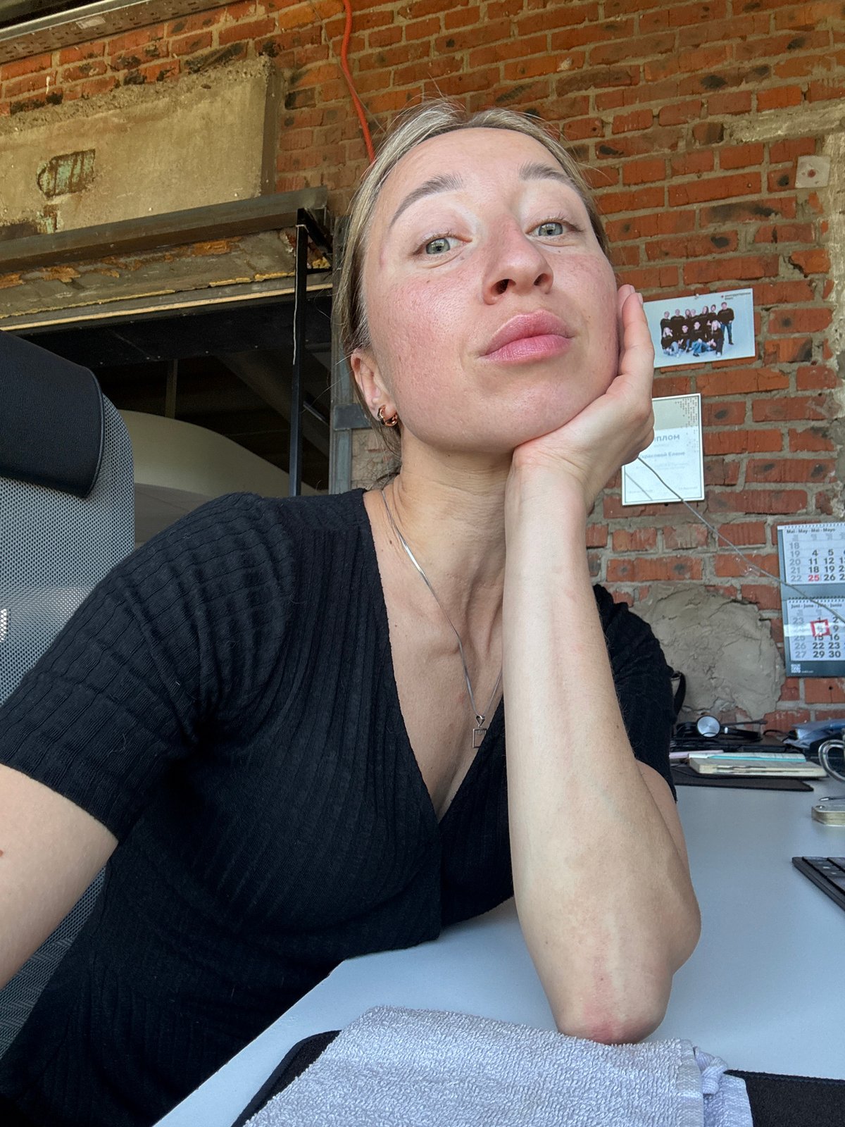Woman takes office selfies during morning work session in Chaikovsky