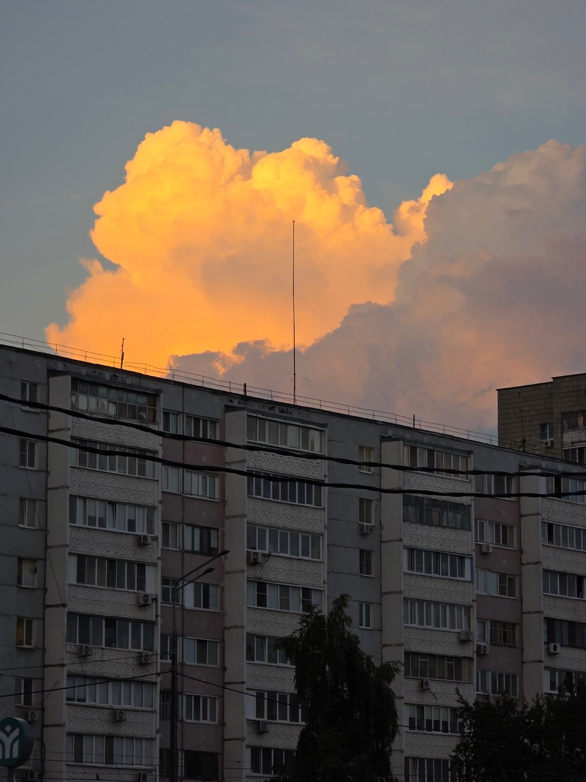 Construction site and apartment blocks at dramatic urban dusk