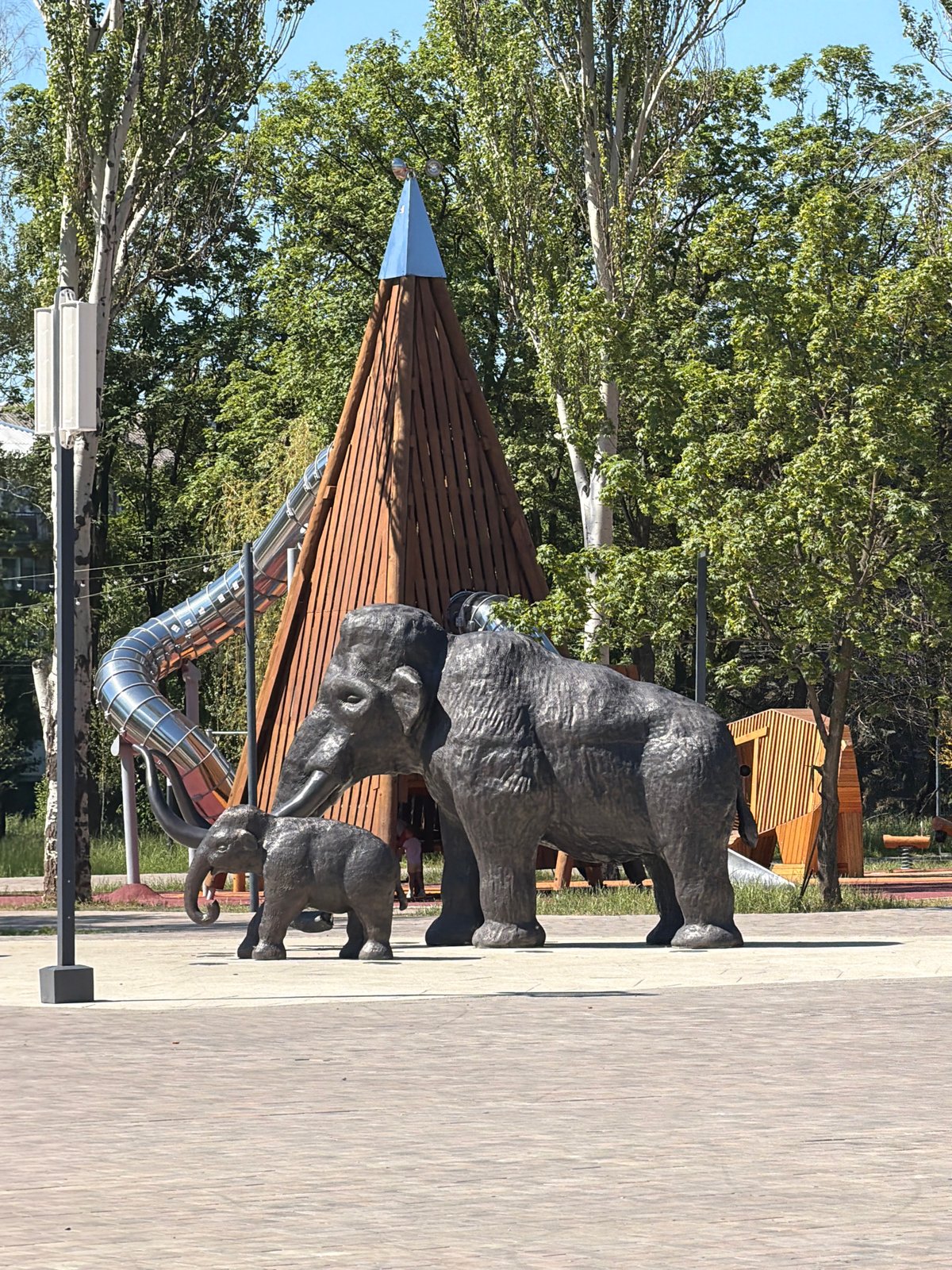 Lazy summer morning at a park with mammoth sculptures and a coffee stop