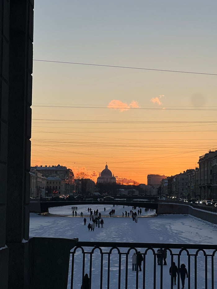Saint Petersburg residents enjoy frozen waterways during winter sunset