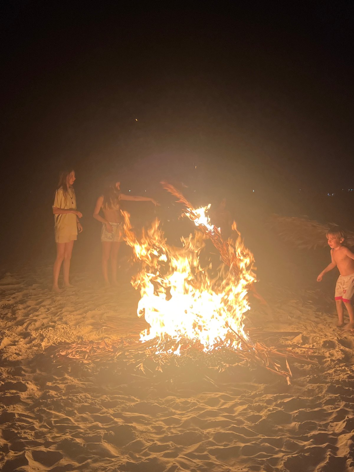 Beach bonfire gathering on the Hoi An shoreline at night