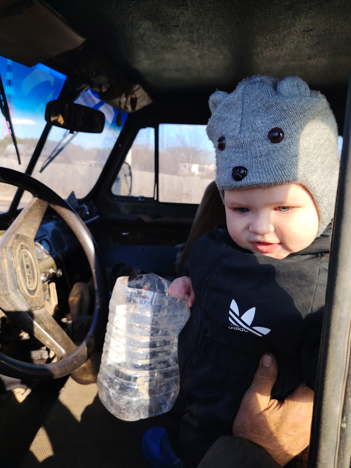Child plays at wheel of military vehicle in Chaikovsky