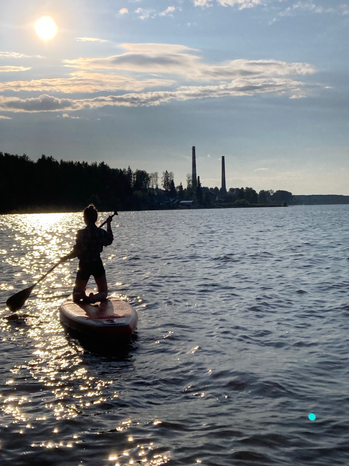 Sunny afternoon paddleboarding on the water in Chaikovsky