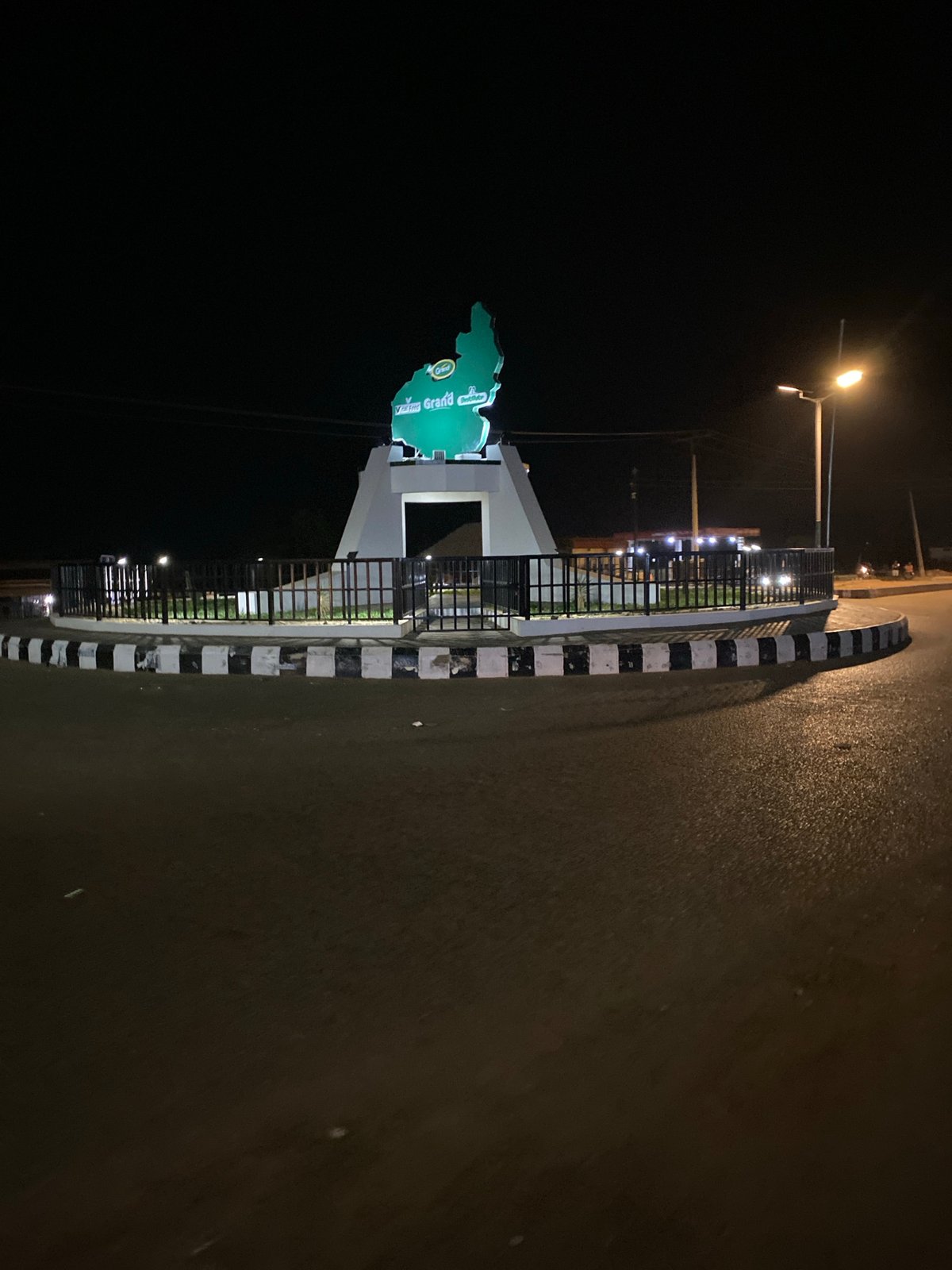 Illuminated map monument captured in nighttime Bukuru street scenes