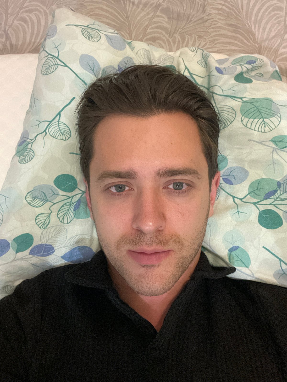 Man rests on patterned bedding in Saint Petersburg
