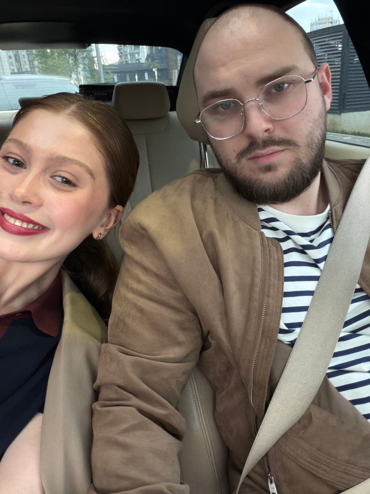 Couple photographed in car during lipstick application in Tbilisi