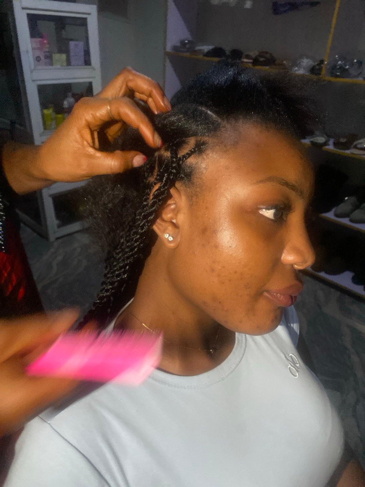 Hair braiding session documented up close in Jos, Nigeria