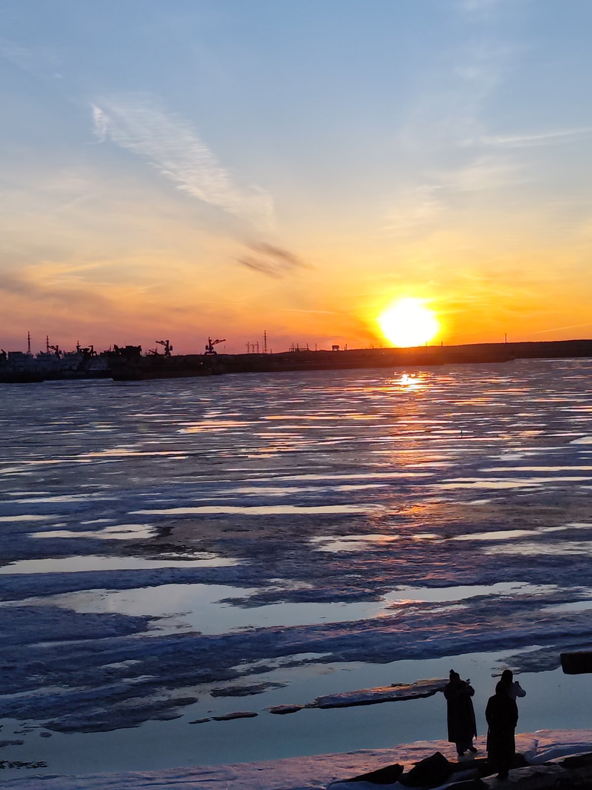 Sunset documented over frozen Kama River in Chaikovsky, Russia