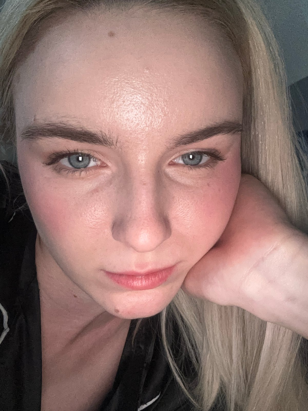 Individual photographed in contemplative pose indoors