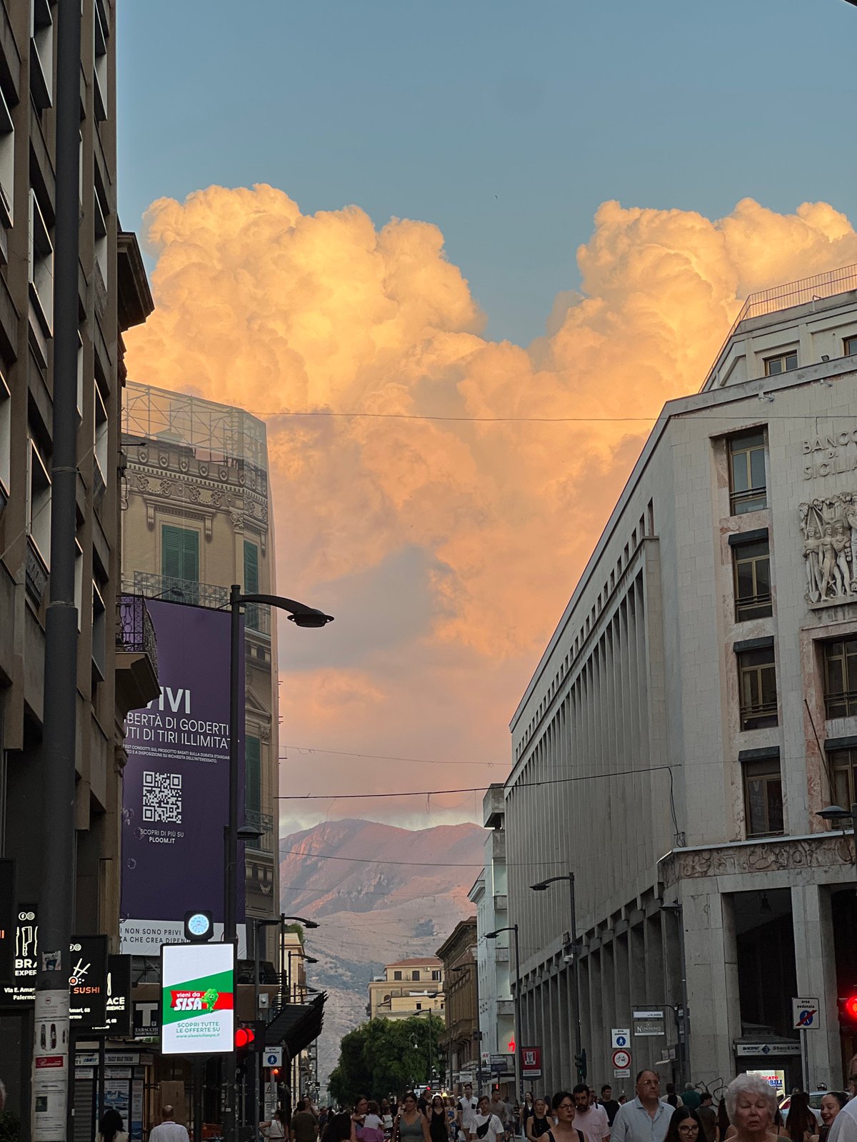 Golden sunset cloud dominates the sky over Palermo streets