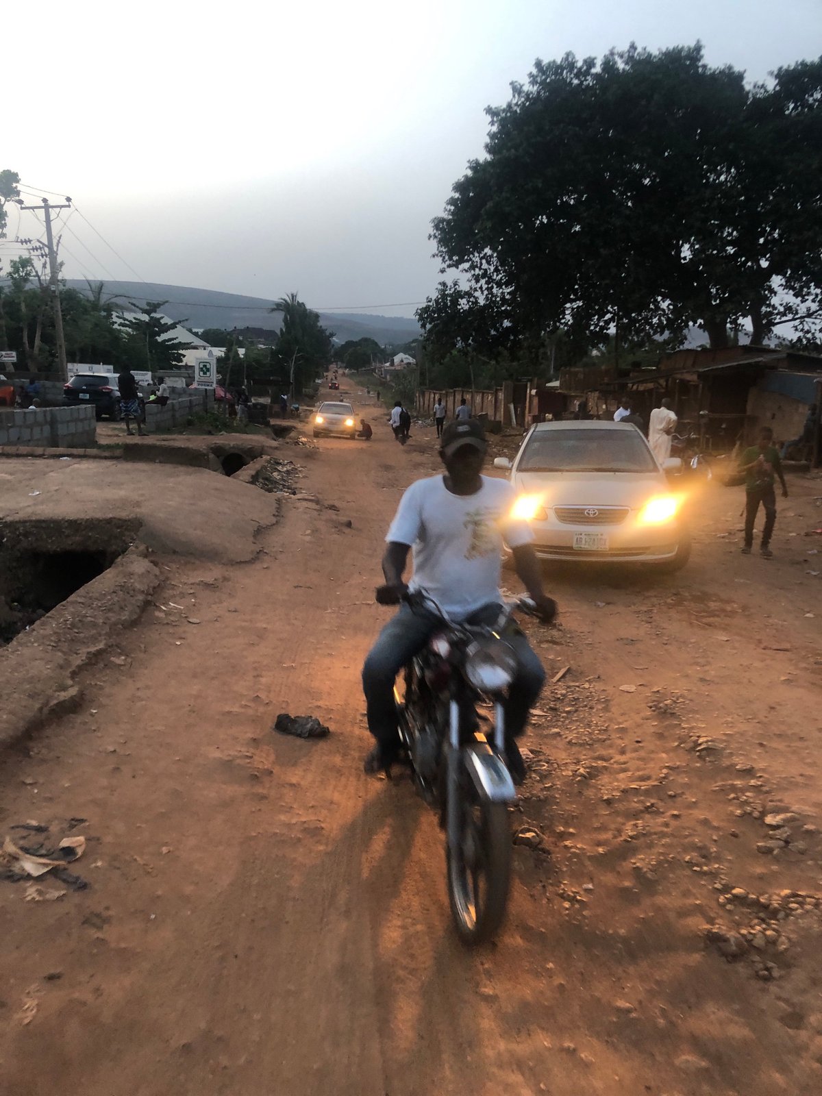 Evening traffic observed on dirt road in Abuja