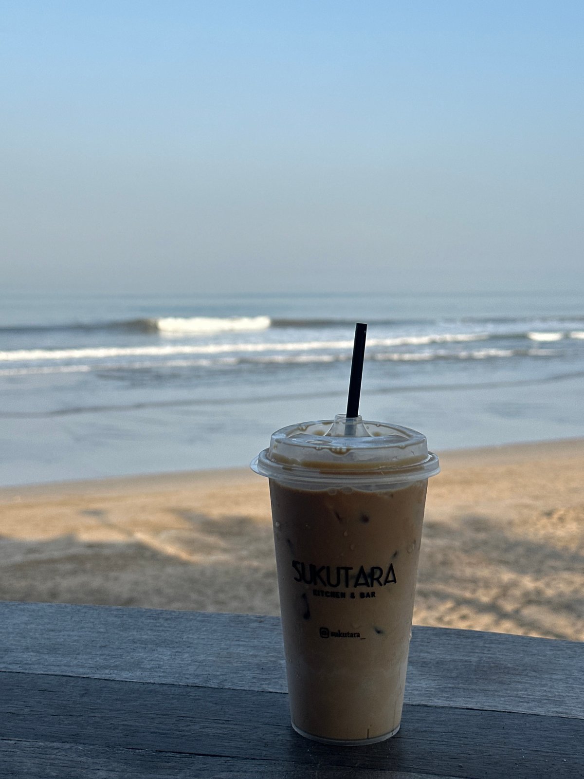 Lazy beach morning in North Kuta with dogs, babies, and iced coffee