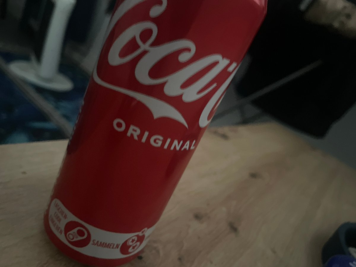 Coca-Cola can spotted on wooden surface in Mannheim