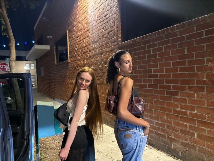 Two women walk hand-in-hand on West Hollywood sidewalk