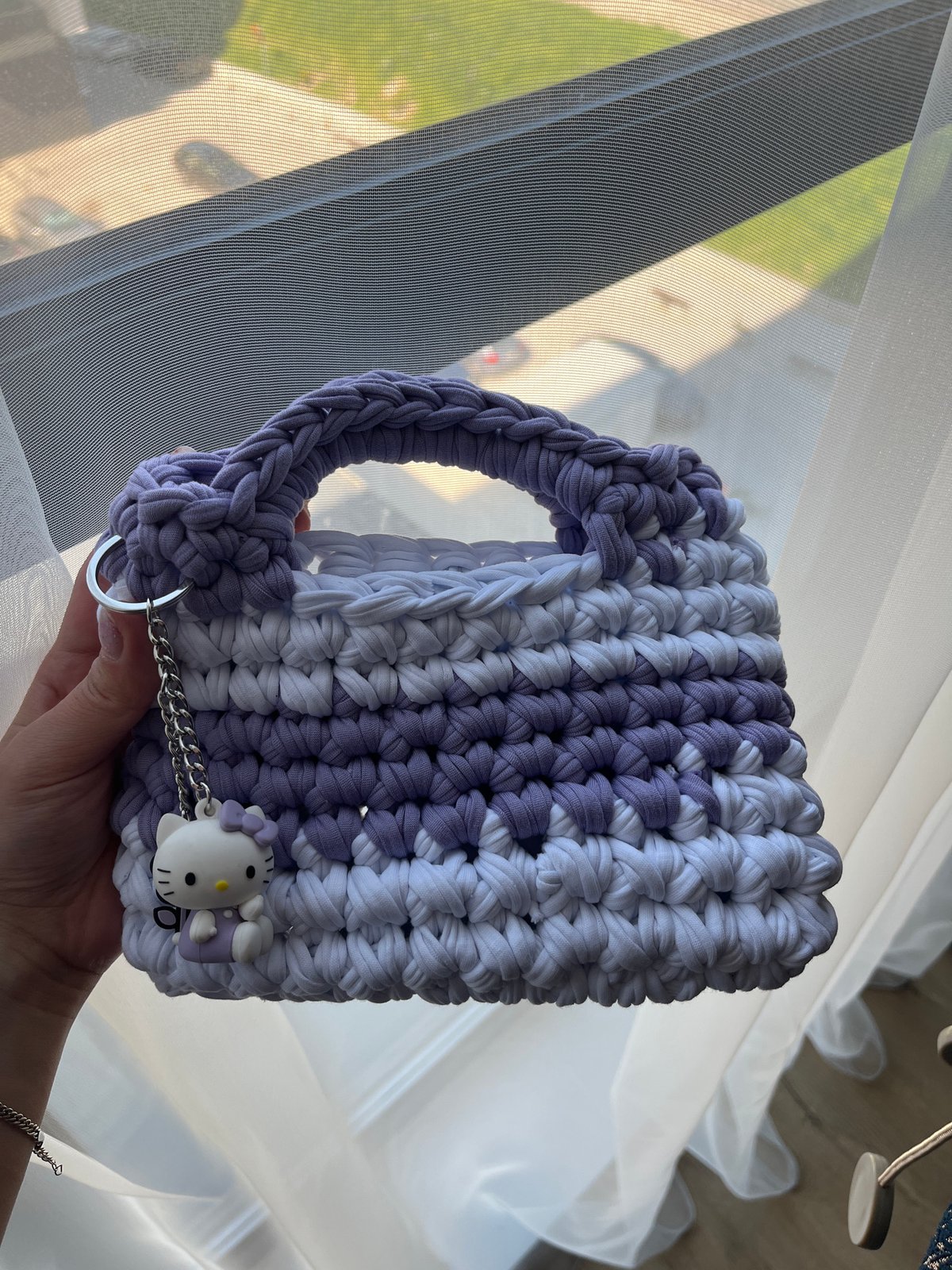 Handmade crocheted purse with Hello Kitty charm displayed in Plovdiv