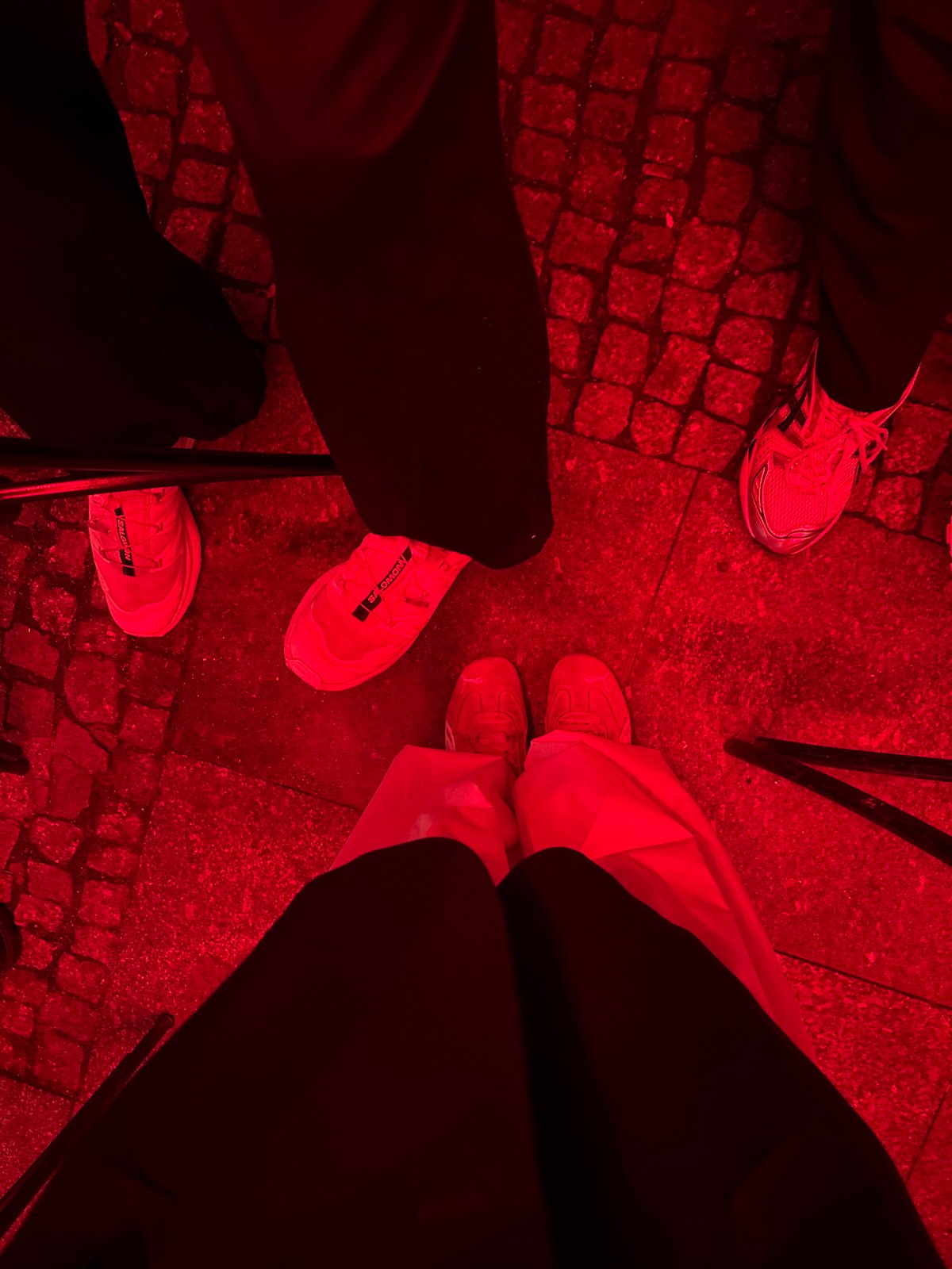 Red-lit nighttime gathering documented across multiple indoor-outdoor venues