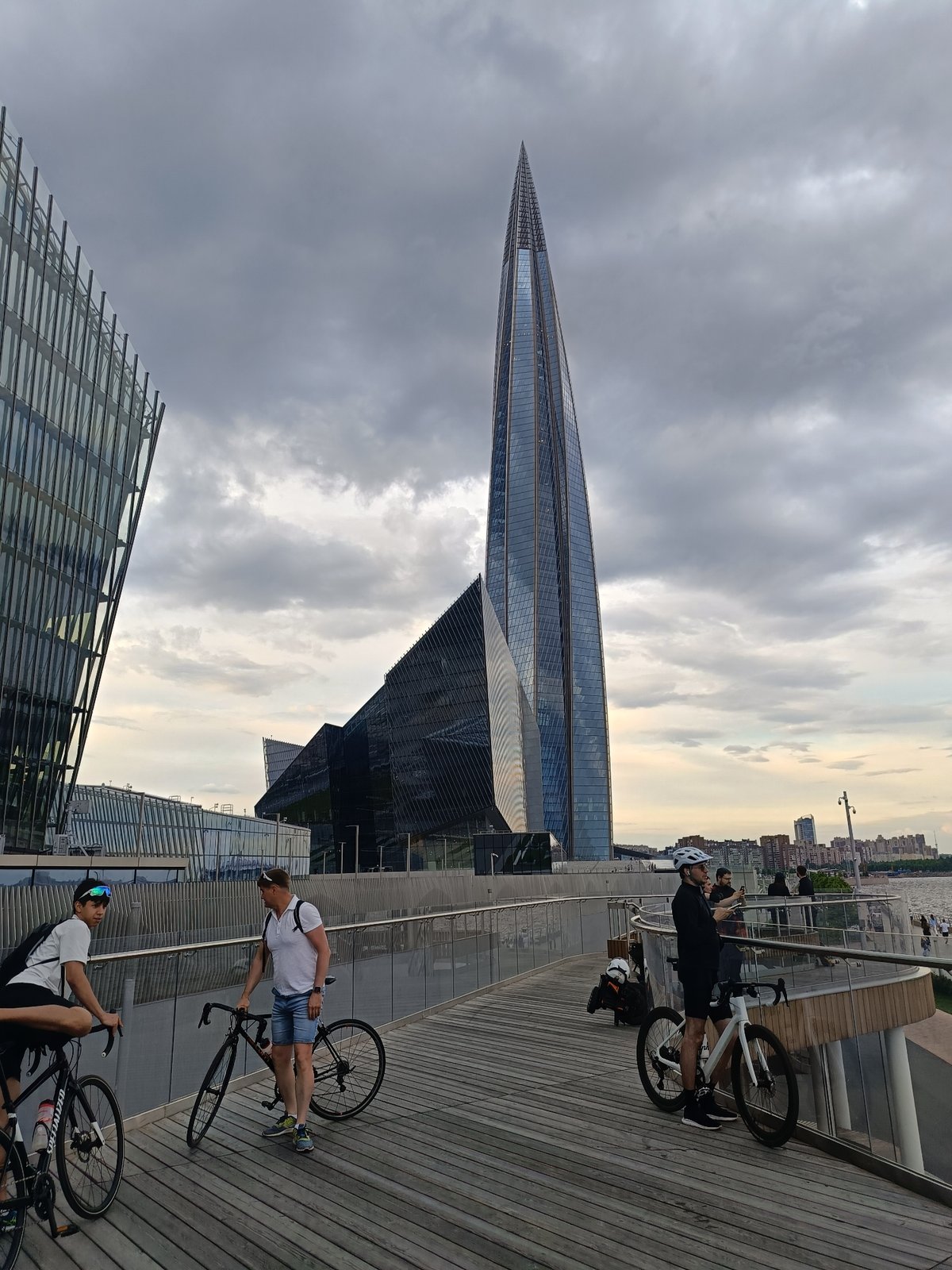 Couples dance salsa outdoors in overcast Saint Petersburg waterfront