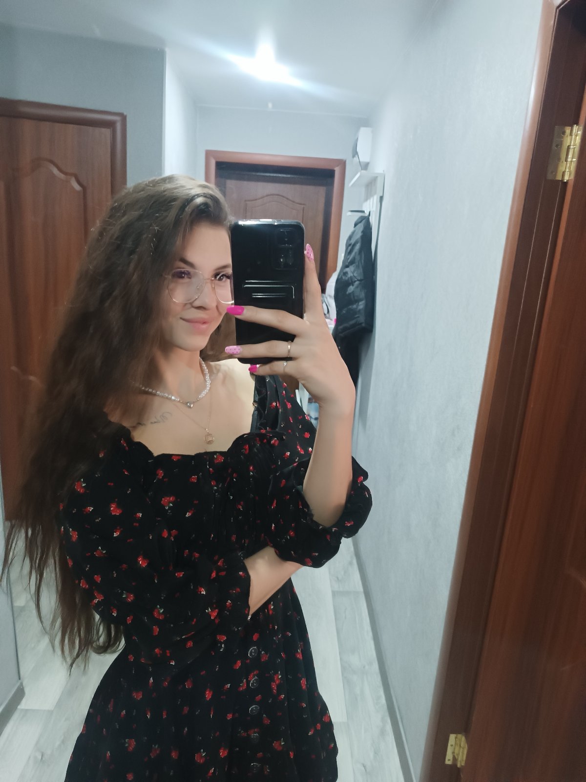 Woman takes selfies in hallway during early morning hours