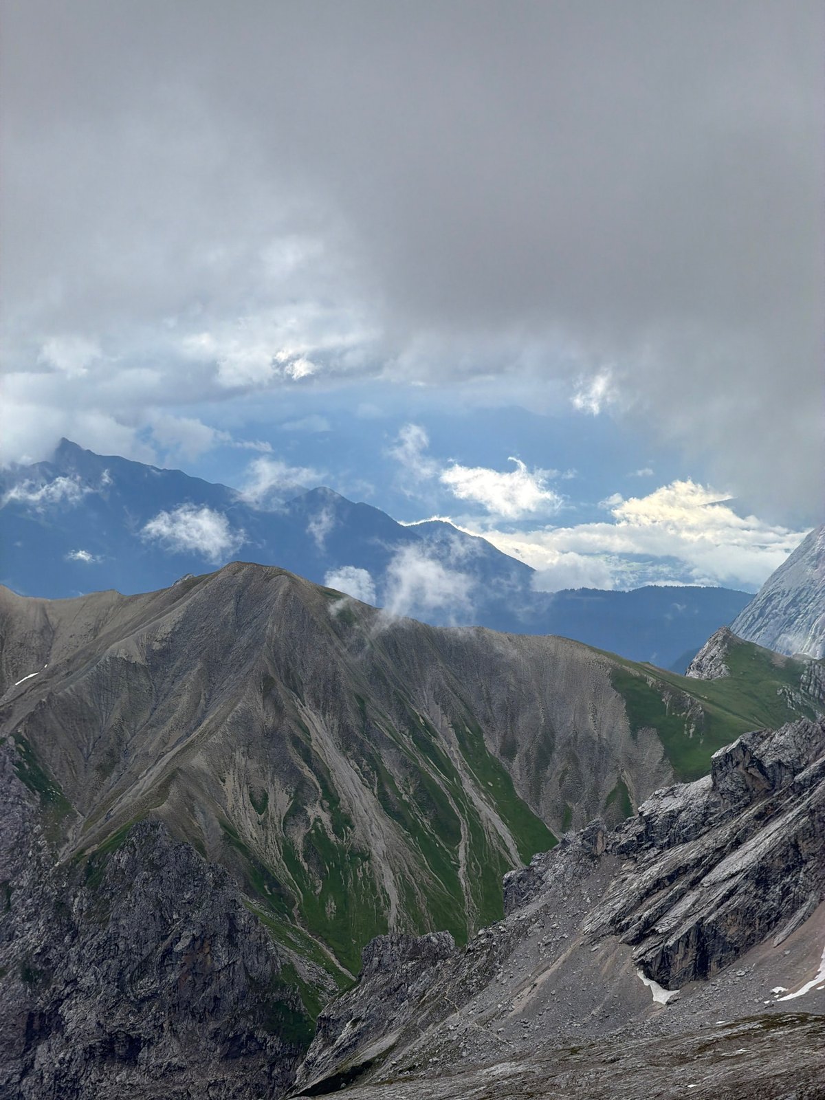 Close-up and wide views of the Zugspitze on a cloudy morning