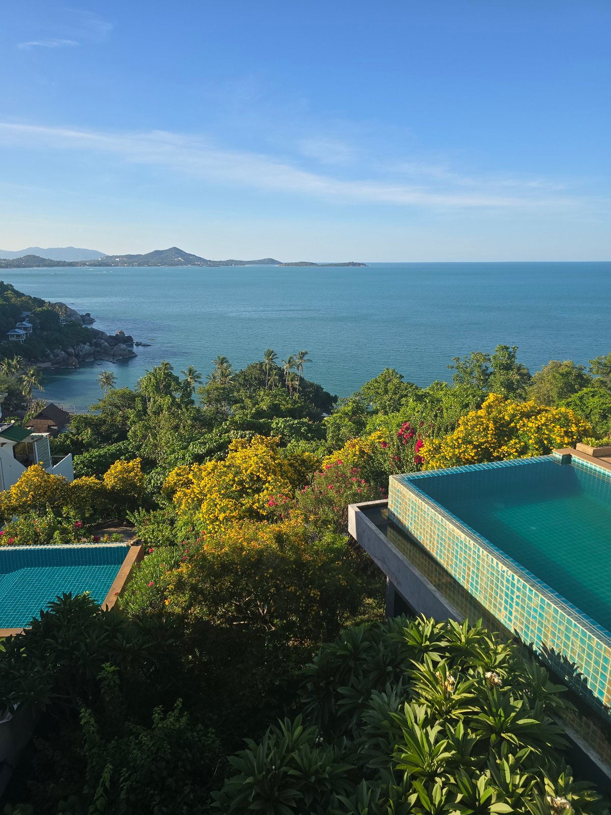 Tropical hillside resort views mixed with busy street-level scooter traffic