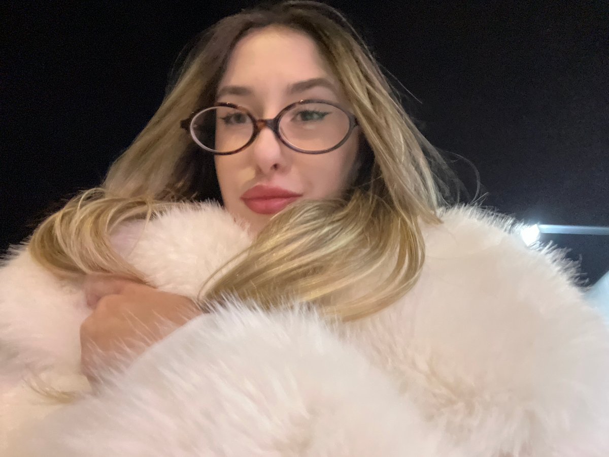 Woman in white fur coat documented across Sofia locations