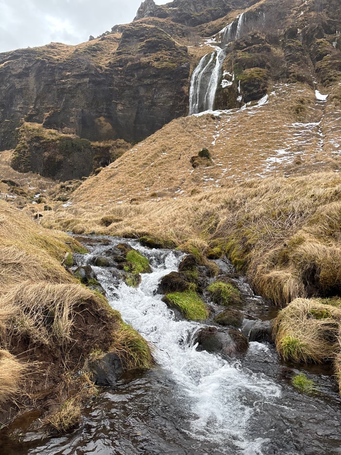 Winter waterfall landscapes documented in Iceland under grey skies