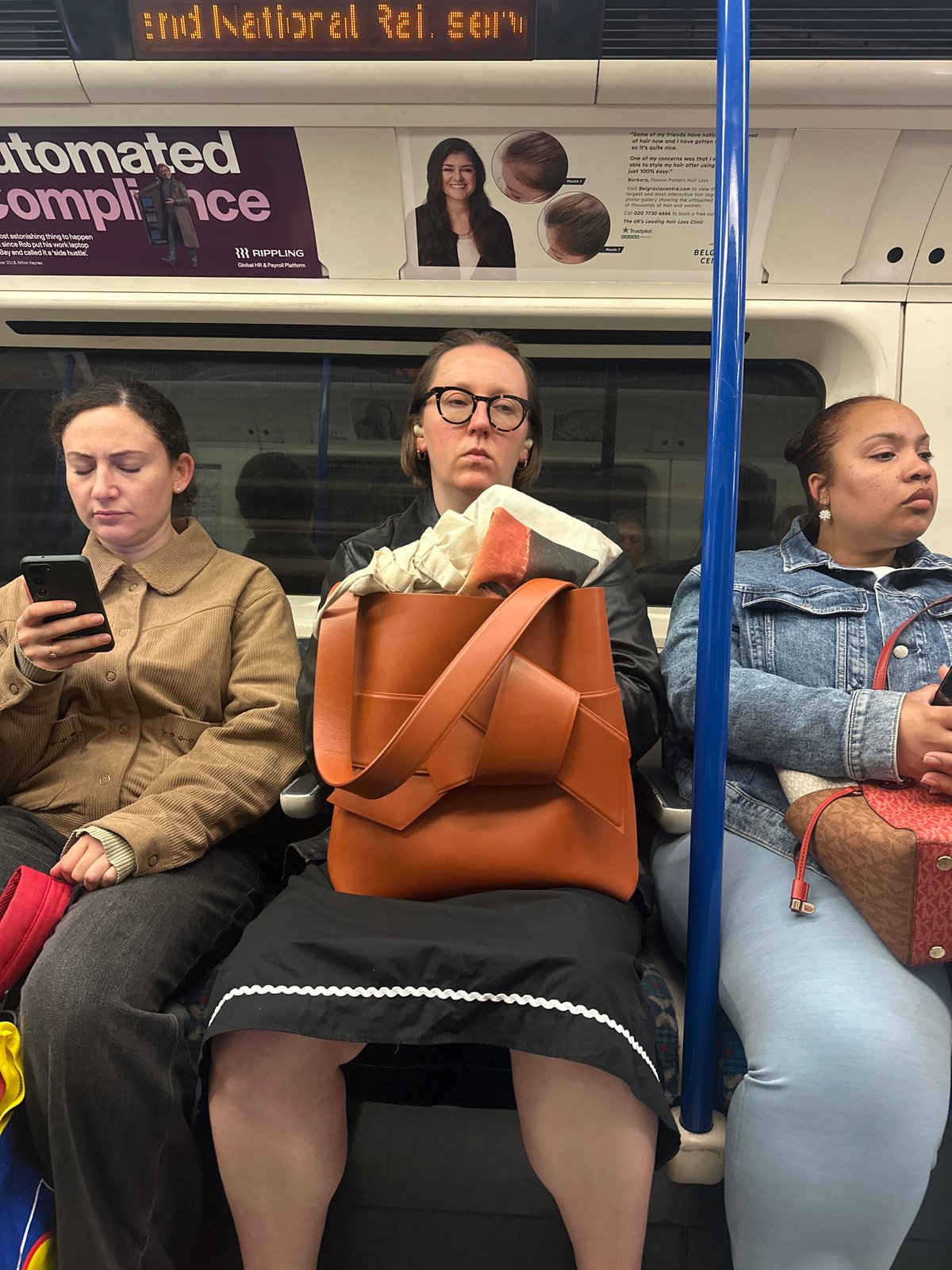 Three Women Photographed on London Underground Train Carriage