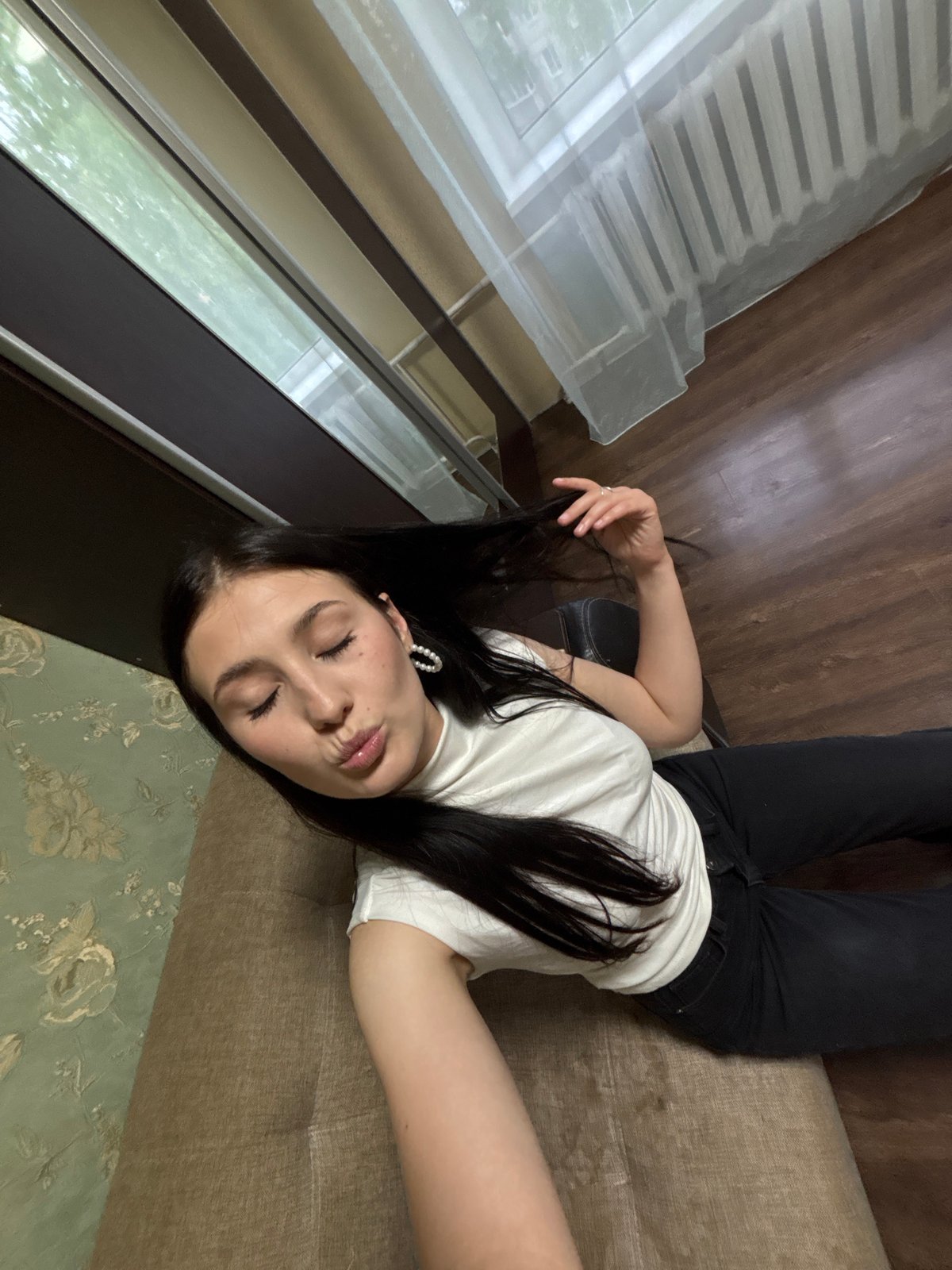 Mirror selfies and a couch pose in Chaikovsky, Russia