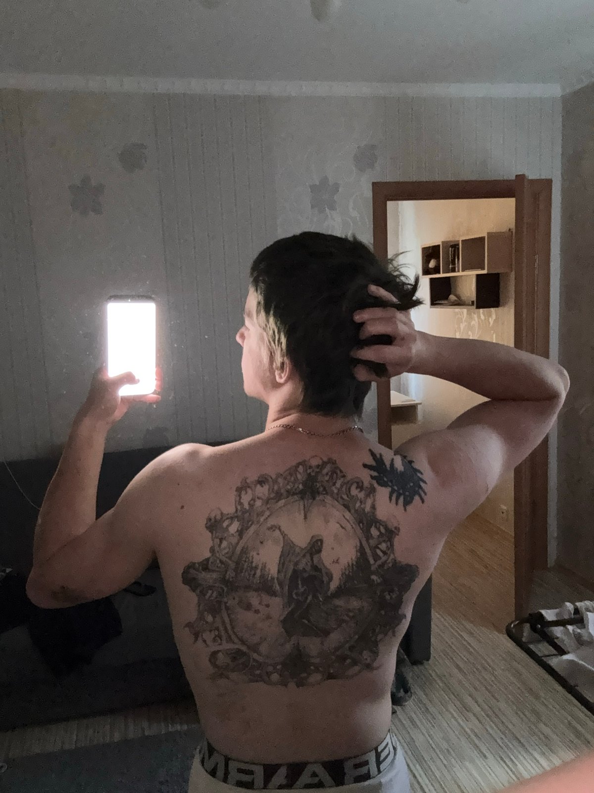 Tattooed leg, fake lavender, phone — casual home shoot in Minsk