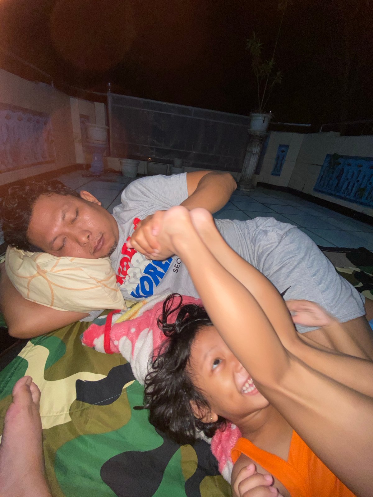 Relaxing on a camo blanket outdoors in Gelam, Indonesia