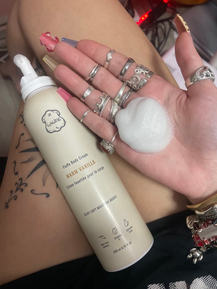 Person documents skincare routine with body cream in Ra'anana