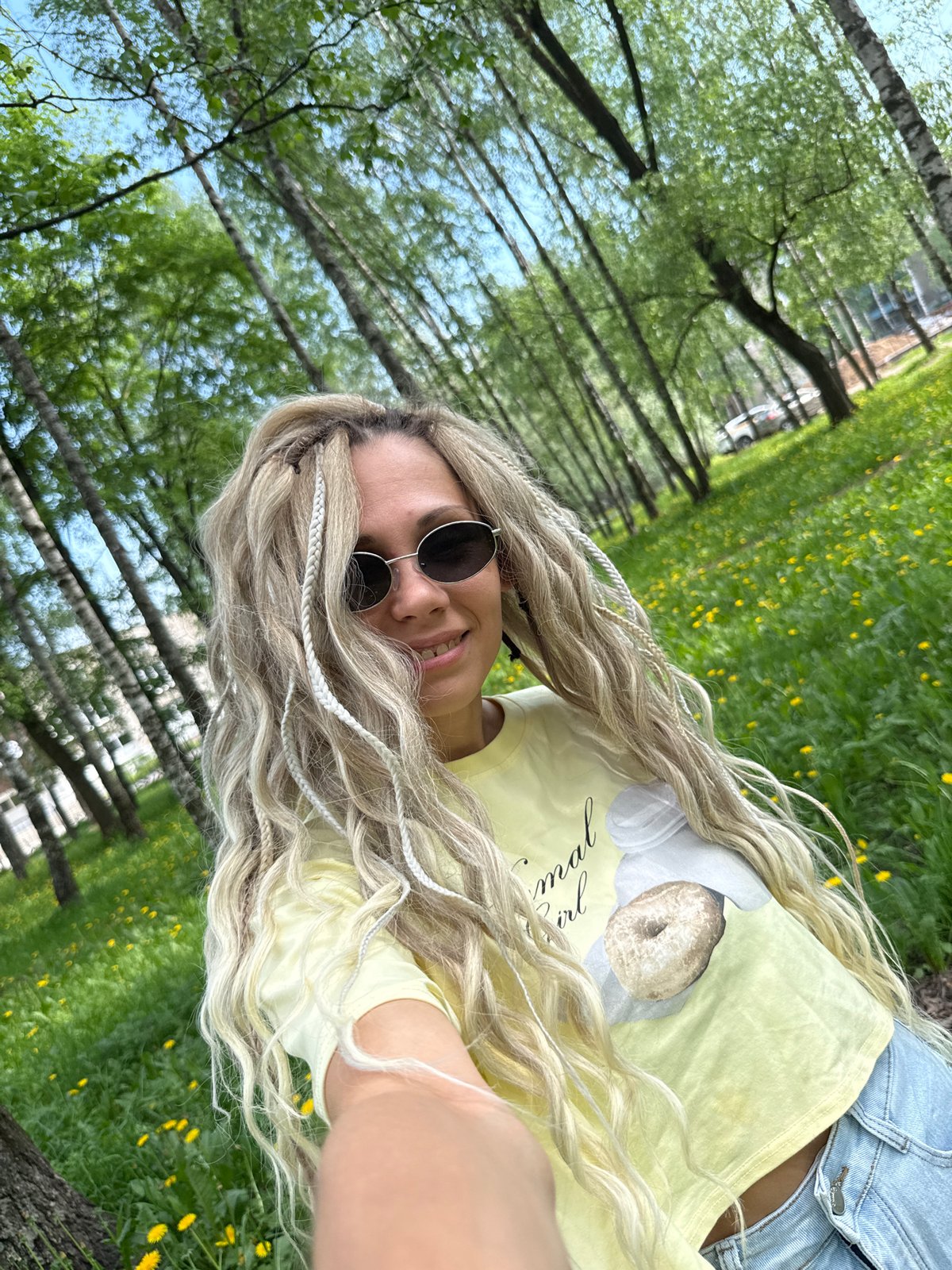 Woman takes casual selfies in Rusanovo park