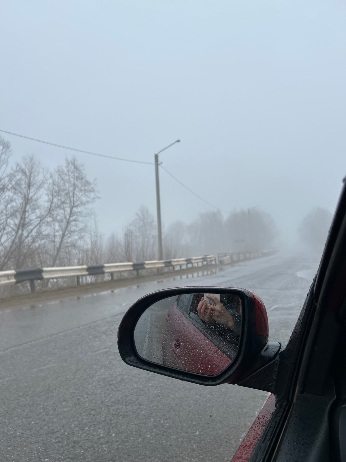 Motorist documents foggy morning drive through Уральское, Russia