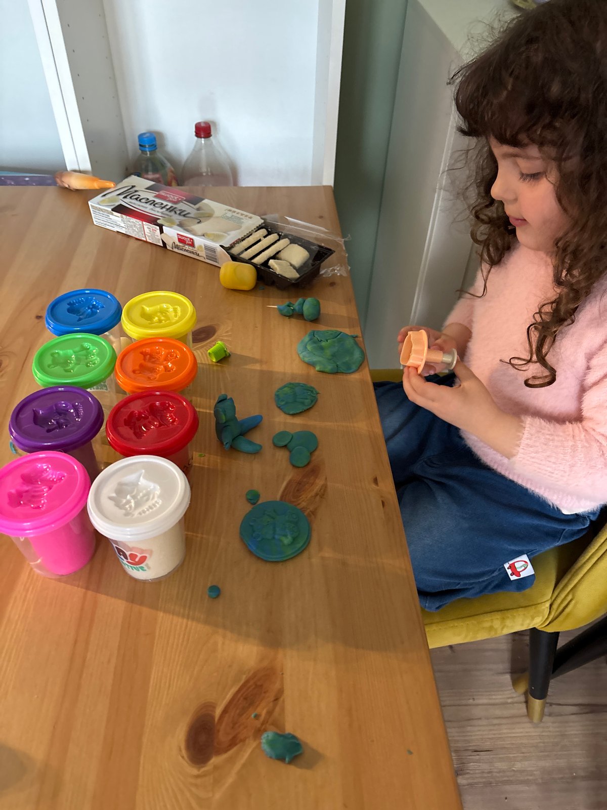 Child plays with Play-Doh at table in Sofia